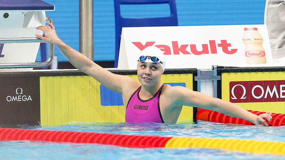 Seen here, Polish swimmer Alicja Tchórz looks up at the clock after a race.