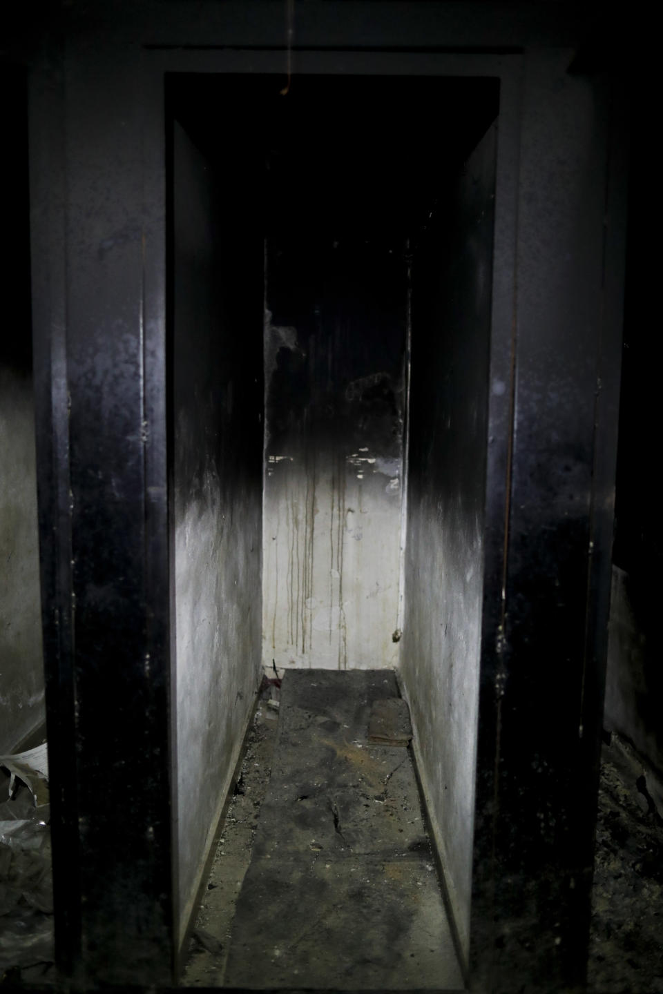 In this July 15, 2018 photo, a burned underground prison cell is abandoned in Tawbeh Prison, where over the years the Army of Islam detained hundreds of people, in Douma, near the Syrian capital Damascus, Syria. The fate of activist Razan Zaitouneh is one of the longest-running mysteries of Syria’s civil war. There’s been no sign of life, no proof of death since gunmen abducted her and three of her colleagues from her offices in the rebel-held town of Douma in 2013. Now Douma is in government hands and clues have emerged that may bring answers. (AP Photo/Hassan Ammar)