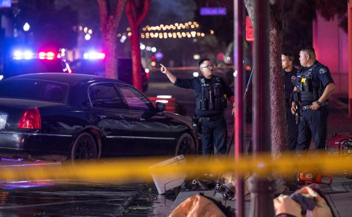 First responders work the scene of a fire Sunday, April 9, 2023 on K Street in Downtown Tulare. A woman was transported from the scene to a local hospital.