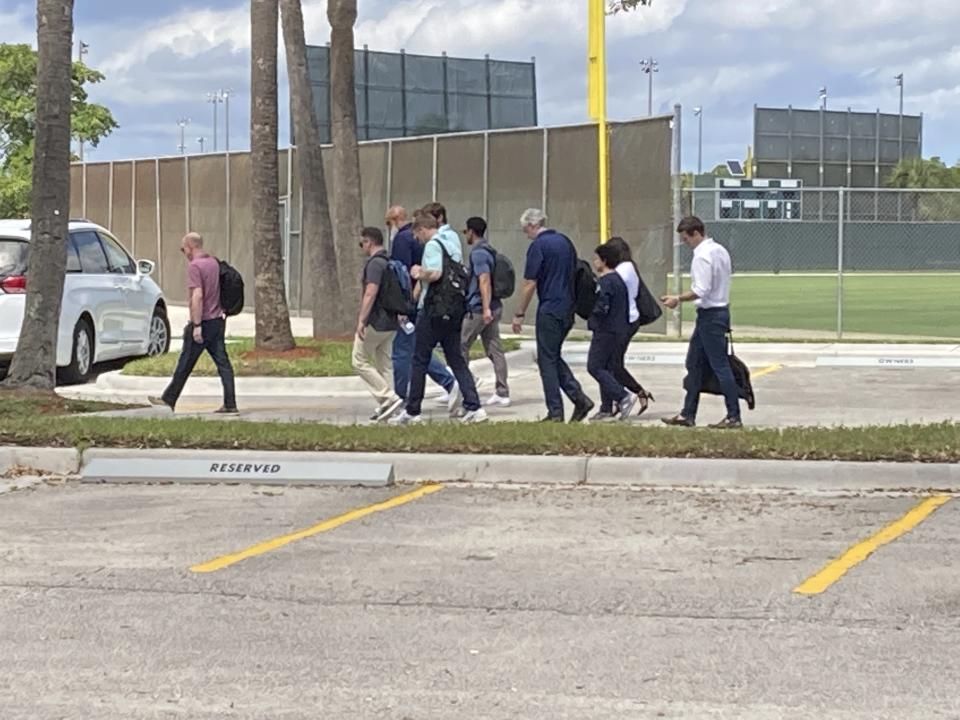 Chief negotiator Bruce Meyer, left, followed by director of analytics Greg Dreyfuss, second from left, and union head Tony Clark, third from left, lead players into negotiations with Major League Baseball on Sunday, Feb. 27, 2022 at Roger Dean Stadium in Jupiter, Fla. (AP Photo/Ron Blum)