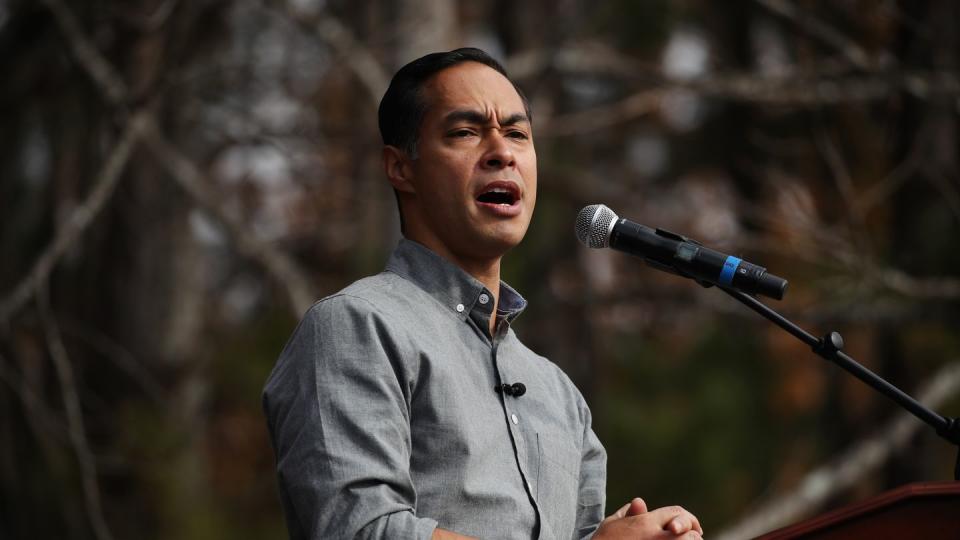 julian castro standing at a podium and microphone and speaking at a political rally
