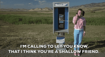 A teenage girl on a payphone saying "I'm calling to let you know, that I think you're a shallow friend"