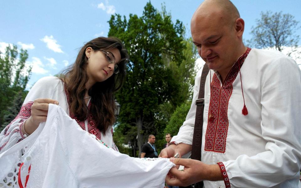 People learn to make traditional embroidered patterns on clothes as they celebrate the Day of the Embroidered Shirt (Vyshyvanka) in Odesa, Ukraine on May 19, 2022.  - Igor Tkachenko/Reuters