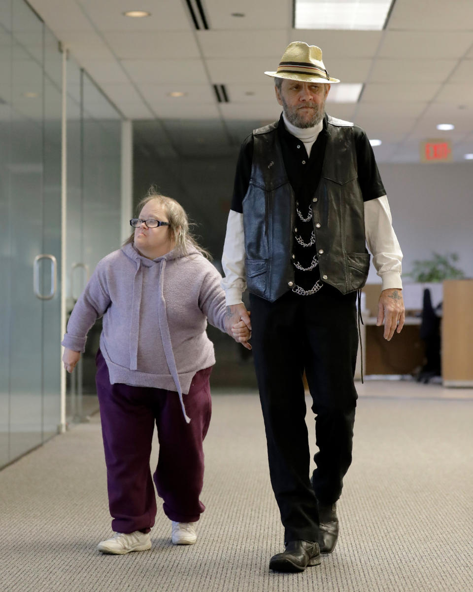 In this Saturday, Dec. 21, 2019 photo, Bobby Goldberg and his sister Debbie arrive at the office of his lawyer, Melissa Anderson, in Bannockburn, Ill. Goldberg has filed a lawsuit claiming he was abused more than 1,000 times in multiple states and countries by the late Donald McGuire, a prominent American Jesuit priest who had close ties to Mother Teresa. (AP Photo/Nam Y. Huh)