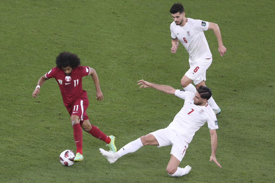 Qatar's Akram Afif, left, compete for the ball with Iran's Alireza Jahan Bakhsh during the Asian Cup semifinal soccer match between Qatar and Iran at Al Thumama Stadium in Doha, Qatar, Wednesday, Feb. 7, 2024. (AP Photo/Hussein Sayed)