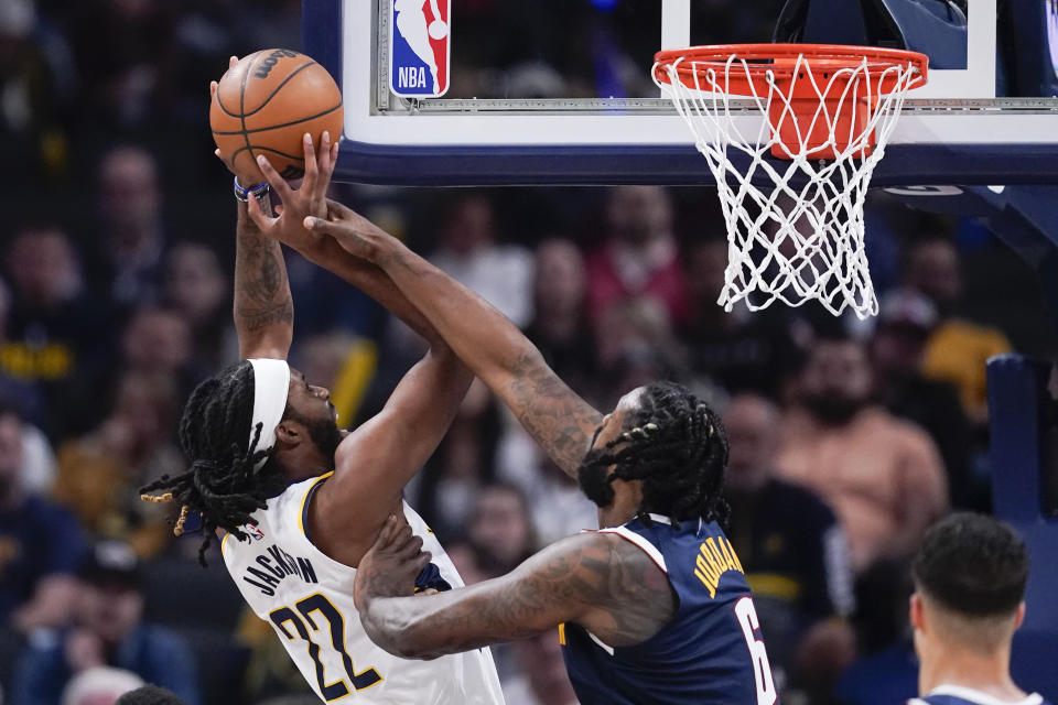 Indiana Pacers' Isaiah Jackson (22) is fouled by Denver Nuggets' DeAndre Jordan (6) as he goes up for a shot during the first half of an NBA basketball game, Wednesday, Nov. 9, 2022, in Indianapolis. (AP Photo/Darron Cummings)