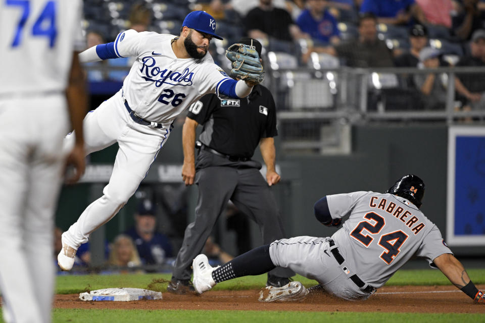 Detroit Tigers' Miguel Cabrera steals third base as the throw from home to Kansas City Royals third baseman Emmanuel Rivera (26) gets past him during the seventh inning of a baseball game, Tuesday, July 12, 2022, in Kansas City, Mo. (AP Photo/Reed Hoffmann)