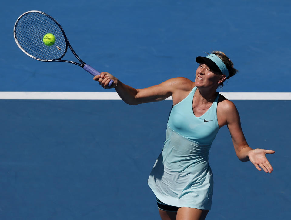 Maria Sharapova of Russia hits a forehand return to Karin Knapp of Italy during their second round match at the Australian Open tennis championship in Melbourne, Australia, Thursday, Jan. 16, 2014.(AP Photo/Aaron Favila)