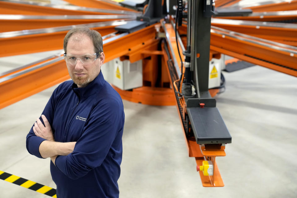 Bob Mumgaard, CEO of Commonwealth Fusion Systems, stands for a photograph near a magnet insulation wrapping machine at their facility, in Devens, Mass., Wednesday, Oct. 11, 2023. Commonwealth is trying to create fusion inside what's called a tokamak. Nuclear fusion, which would be a new source of carbon-free energy, melds two hydrogen atoms together to produce a helium atom and a lot of energy. (AP Photo/Steven Senne)