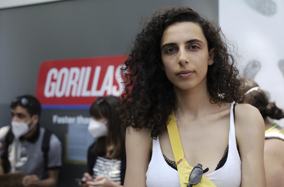 Zeynep, center, a Gorillas rider from Turkey who declined to give her last name for fear of facing repercussions from the company, poses for a portrait in front of a depot for German startup Gorillas, a grocery delivery company, during a protest against the firing of a colleague in Berlin, Germany, Thursday, June 10, 2021. The company Gorillas operates in dozens of cities across Germany, France, Italy, the Netherlands and Britain, and has already set its sights on New York. (AP Photo/Markus Schreiber)