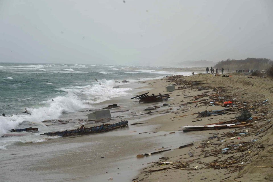 The wreckage from a capsized boat washes ashore at a beach near Cutro, southern Italy, Sunday, Feb. 26, 2023. Rescue officials say an undetermined number of migrants have died and dozens have been rescued after their boat broke apart off southern Italy. (Antonino Durso/LaPresse via AP)