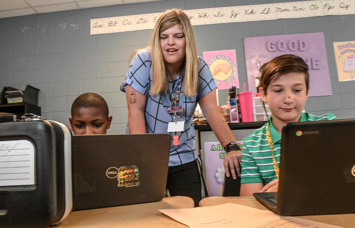 MeMe New, Special Education teacher, works with Deanthony Patterson, lett, and Frank Forgnoni, right, was named Rookie Teacher of the Year at Robert Anderson Middle School in Anderson, S.C. Wednesday, April 24, 2024.