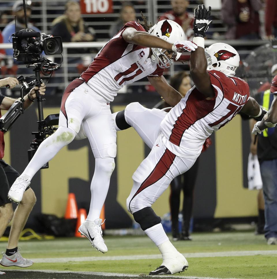 Larry Fitzgerald (L) knocking down a 300-pounder after a TD. (AP)