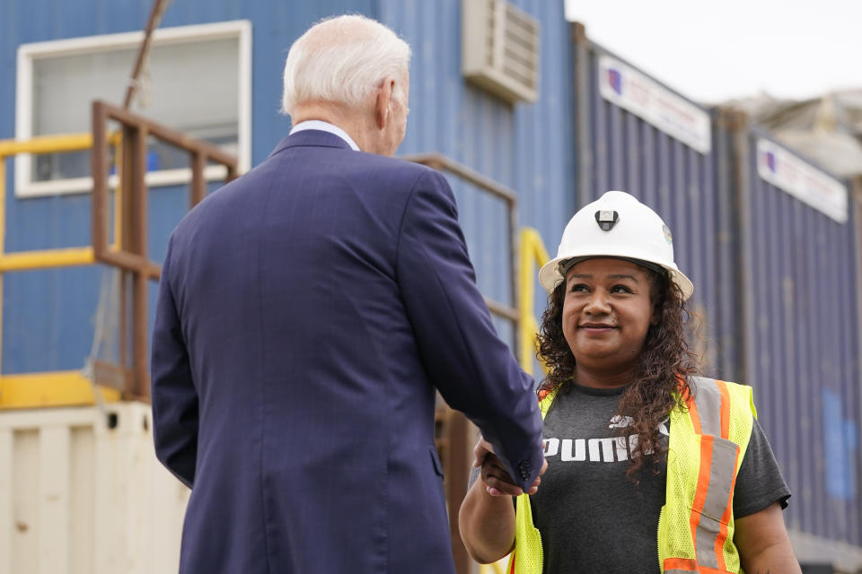 President Joe Biden shakes hands with Yurvina Hernandez before speaking about infrastructure investments at the LA Metro, D Line (Purple) Extension Transit Project - Section 3, in Los Angeles, Thursday, Oct. 13, 2022. (AP Photo/Carolyn Kaster)