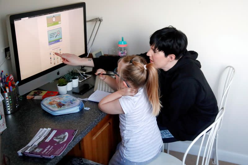 FILE PHOTO: Children attend school lessons at home in Milton Keynes