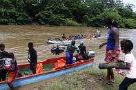 Migrants arrive in Lajas Blancas, Darien, Panama, Saturday, Oct. 23, 2021. A rising number of female migrants have reported suffering sexual abuse while crossing the treacherous Darien Gap between Colombia and Panama. Seeking to draw attention to the issue, a group of Panamanian lawmakers travelled Saturday on a fact-finding mission to speak with victims and authorities in the remote province. (AP Photo/Ana Renteria)