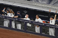 New York Yankees in the dugout react to Aaron Judge's eighth-inning, two-run home run in a baseball game against the Boston Red Sox, Sunday, Aug. 2, 2020, at Yankee Stadium in New York. (AP Photo/Kathy Willens)