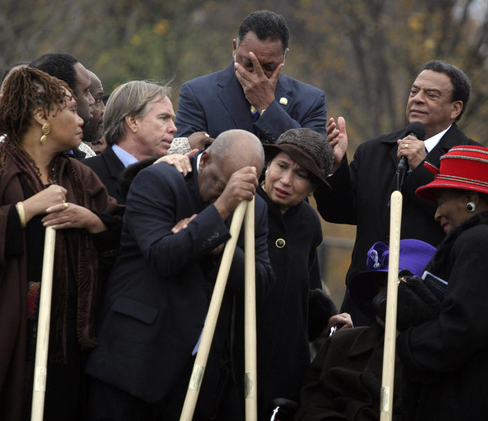 Rev. Jesse Jackson, top center, and Rep. John Lewis, D-Ga., leaning on shovel, become emotional as Amb. Andrew Young, top right, speaks about the significance of the late Dr. Martin Luther King Jr., during the breaking ground for the Martin Luther King Memorial on the National Mall in Washington Monday Nov. 13, 2006. Consoling Rep. Lewis are former Labor Secretary Alexis Herman, center, and fashion designer Tommy Hilfiger, second from left. At lower right, Martin Luther King Jr.'s sister Christine King Farris. (Photo: Lauren Victoria Burke/AP)