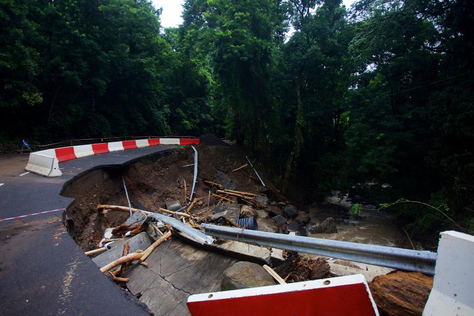 This photograph shows a damaged road in Vieux-Fort, on October 22, 2023, on the island of Guadeloupe, after the path of Hurricane Tammy. Confined for a few hours on October 21, 2023 in the path of Hurricane Tammy, Guadeloupe has not yet seen the last of the bad weather: heavy rains fell on the archipelago on October 22, swelling rivers that have burst their banks and causing local flooding.