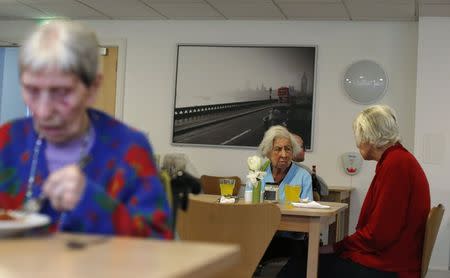 Residents have lunch at the Colbrooke House care facility run by a private company working on behalf of the local government and housing association in southeast London February 13, 2015. REUTERS/Suzanne Plunkett