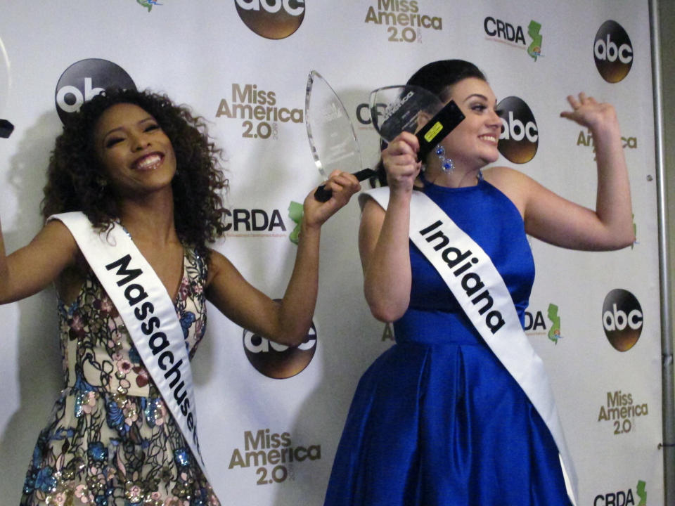 Miss Massachusetts Gabriela Taveras, left, and Miss Indiana Lydia Tremaine celebrate after winning preliminary competition awards in the Miss America pageant Friday Sept. 7, 2018 in Atlantic City, N.J. Taveras won the onstage interview and Tremaine won the talent portion. (AP Photo/Wayne Parry)