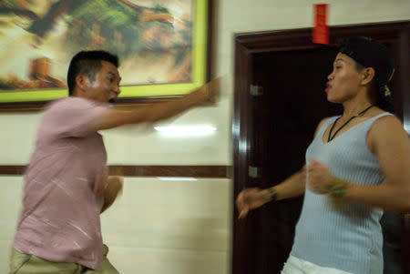 Huang Wensi play-fights with her brother-in-law at home in Lianjiang, Guangdong province, China, June 30, 2018. REUTERS/Yue Wu