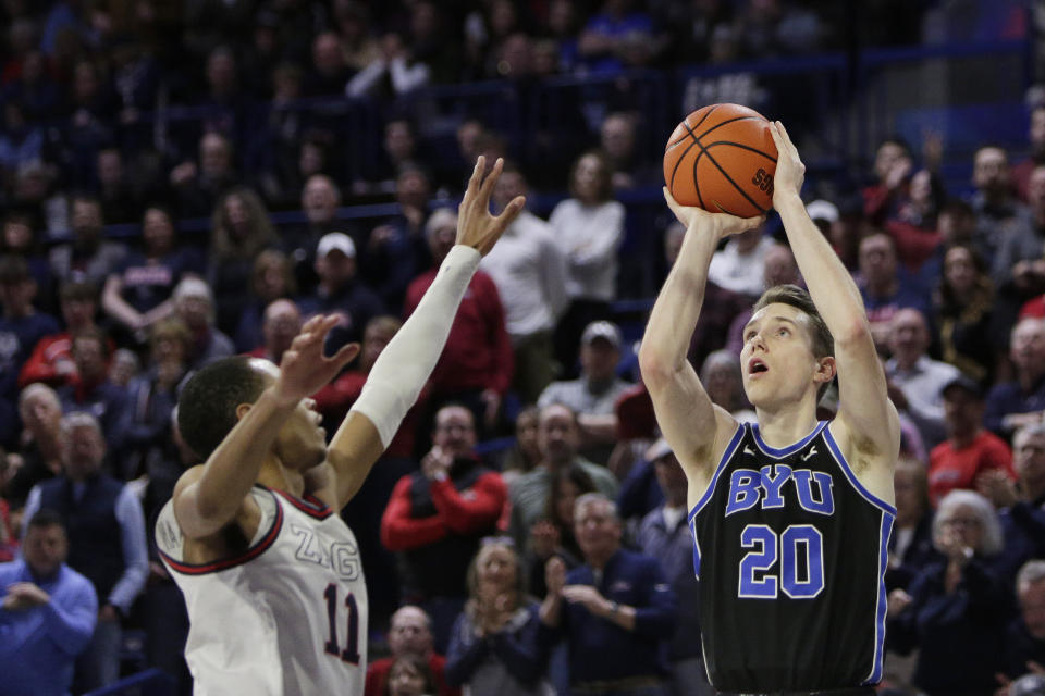 BYU guard Spencer Johnson (20) shoots while defended by Gonzaga guard Nolan Hickman (11) during the second half of an NCAA college basketball game Saturday, Feb. 11, 2023, in Spokane, Wash. Gonzaga won 88-81. (AP Photo/Young Kwak)