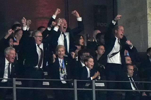 The Prince of Wales (right) celebrates