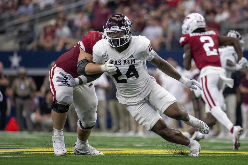 Sep 30, 2023; Arlington, Texas; Texas A&M Aggies linebacker Chris Russell Jr. (24) rushes past the Arkansas Razorbacks offensive line during the second half at AT&T Stadium. Jerome Miron-USA TODAY Sports