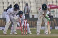 Pakistan Muhammad Rizwan, right, is bowled out by England's Jack Leach during the second day of the second test cricket match between Pakistan and England, in Multan, Pakistan, Saturday, Dec. 10, 2022. (AP Photo/Anjum Naveed)