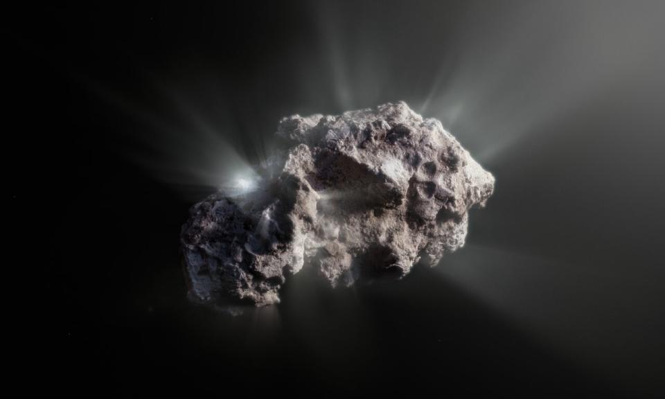 A grey mishappen craggy rock in space