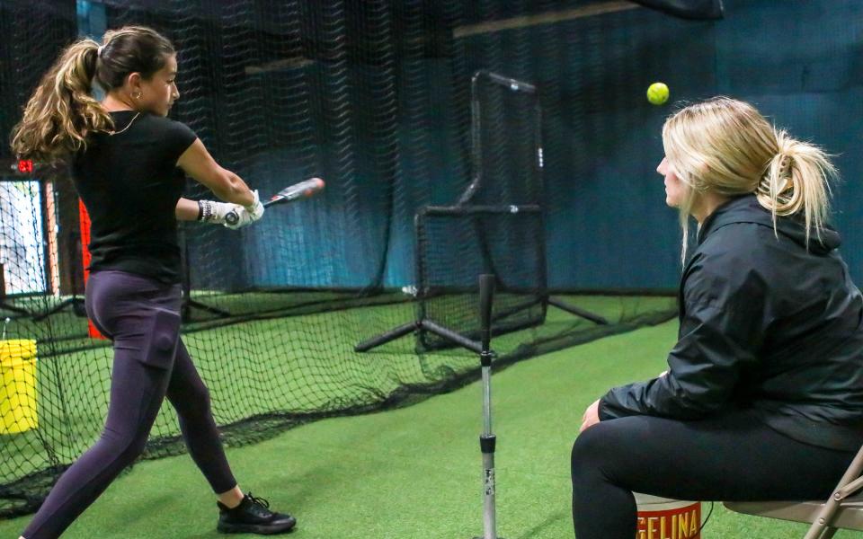 Kia Furtado rips a line drive off the Tee under the tutelidge of instructor Elyse Tavares at the newly located Inside The Park Batting Cages in New Bedford.