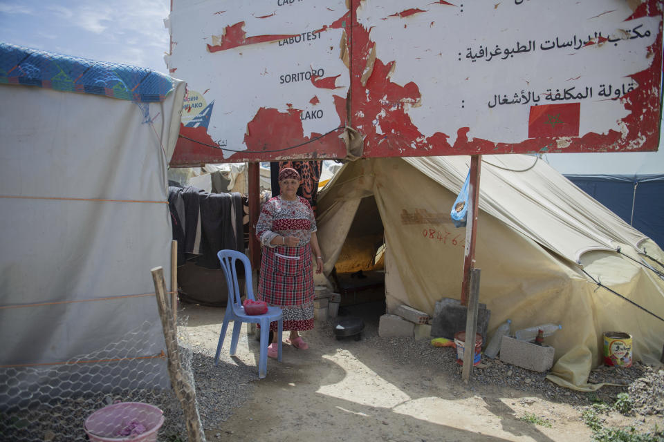 Khadija, a woman who was displaced by the earthquake stands outside her tend, in Amizmiz, near Marrakech, Thursday, April 4, 2024. (AP Photo)