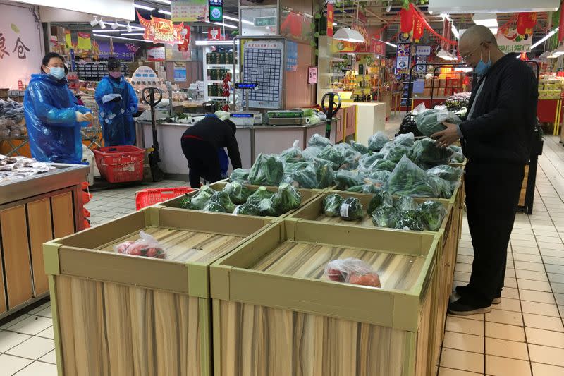 Customer shops for vegetables at a supermarket in Wuhan, the epicentre of the novel coronavirus outbreak