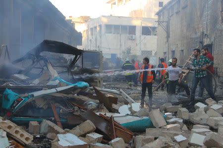 Civil defence members put out a fire at a site hit by airstrikes in Idlib, Syria September 29, 2016. REUTERS/Ammar Abdullah