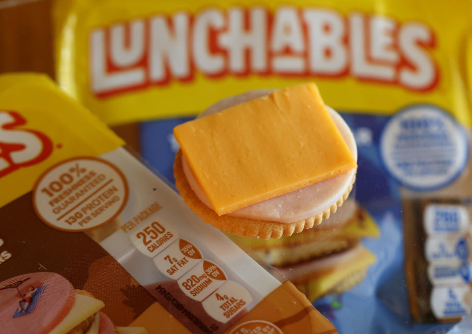 Lunchables package with cracker, cheese slice, and meat on top, nutrition facts visible