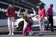 Helio Castroneves, of Brazil, celebrates winning the Indianapolis 500 auto race at Indianapolis Motor Speedway with Adriana Henao, left, and Mikaella Castroneves, Sunday, May 30, 2021, in Indianapolis. (AP Photo/Darron Cummings)