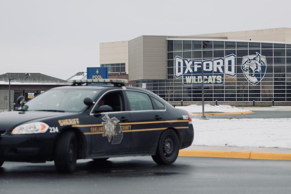 An Oakland County Sheriff sits outside of Oxford High School in Oxford, Mich. on Dec. 1, 2021. 