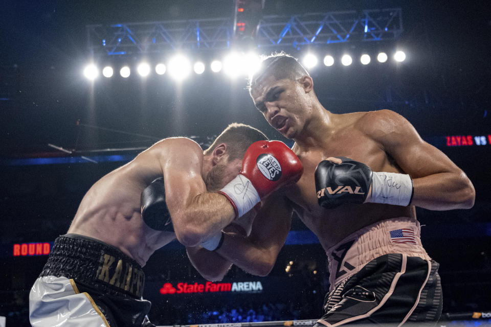 Xander Zayas, right, lands a punch on Dan Karpency during a boxing bout in Atlanta on Saturday, Oct. 23, 2021. (AP Photo/Ben Gray)