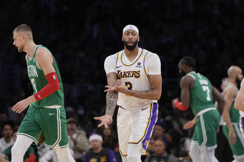 Los Angeles Lakers forward Anthony Davis reacts after making a 3-point basket during the first half of an NBA basketball game against the Boston Celtics, Monday, Dec. 25, 2023, in Los Angeles. (AP Photo/Ryan Sun)