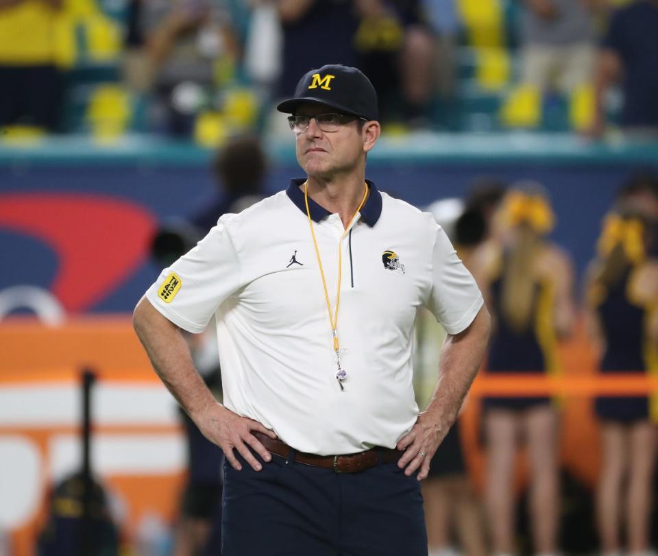 Michigan coach Jim Harbaugh watched his team warm up before the Orange Bowl against Georgia on Friday, Dec. 31, 2021, in Miami Gardens, Florida.