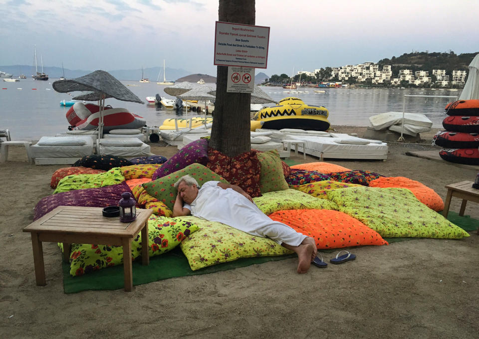 <p>A man sleeps on the beachfront after spending the night outdoors following an earthquake in Bitez, a resort town about 6 kilometers (4 miles) west of Bodrum, Turkey, Friday, July 21, 2017. (Photo: Ayse Wieting/AP) </p>