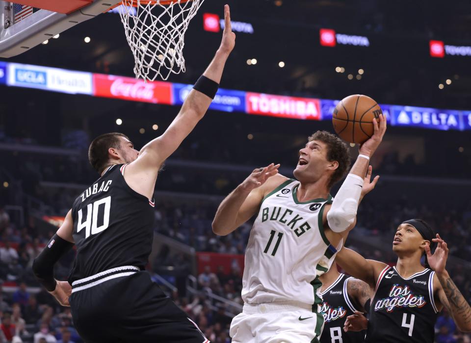 Bucks center Brook Lopez goes up for a shot near the basket against Clippers center Ivica Zubac during the first half Friday night at Crypto.com Arena in Los Angeles.