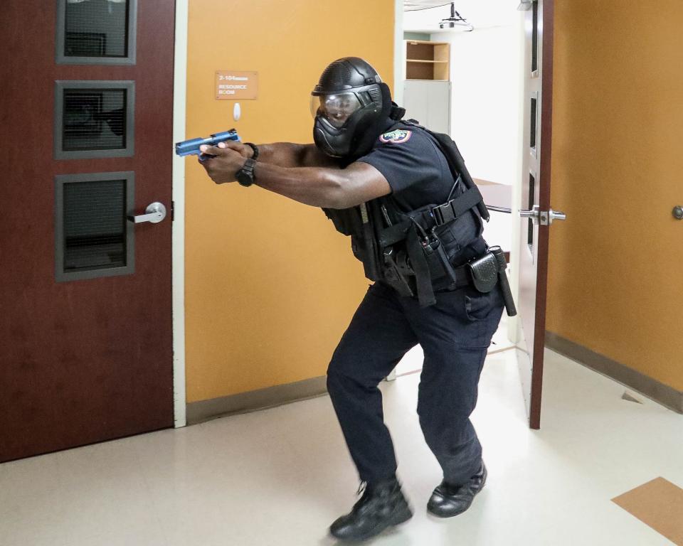 Palm Beach Police officer Anducchi Augustin has his weapon drawn in active shooter training Friday at Palm Beach Public School.