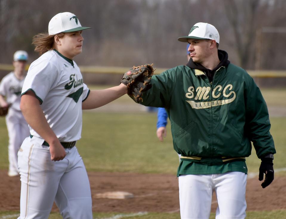 SMCC's Brent Spaulding (left) is greeted by his head coach Zach Parran after a win over Ida last season.