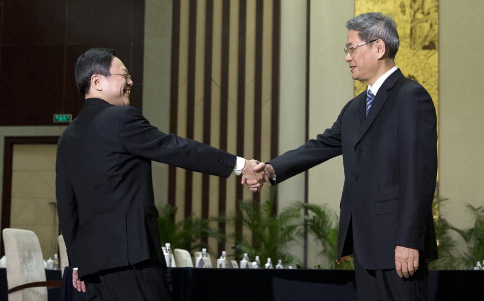 Wang Yu-chi, front left, head of Taiwan's Mainland Affairs Council, shakes hands with Zhang Zhijun, front right, director of China's Taiwan Affairs Office, before their meeting in Nanjing, in eastern China's Jiangsu Province, Tuesday, Feb. 11, 2014. Taiwan and China are holding their highest-level talks since splitting amid a civil war 65 years ago, hoping to further boost contacts and ease lingering tensions, even as political developments on the self-governing island swing away from Beijing's goal of eventual unification. (AP Photo/Alexander F. Yuan)