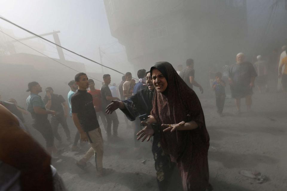 PHOTO: Palestinians react at the site of Israeli air strikes in Khan Younis in the southern Gaza Strip, Oct.26, 2023. (Mohammed Salem/Reuters)