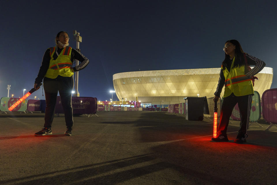 Street marshals work prior to the World Cup group G soccer match between Brazil and Serbia, at the Lusail Stadium in Lusail, Qatar, Thursday, Nov. 24, 2022. The 1998 World Cup in France had Ricky Martin. In Qatar, the tune that nests itself in the head is the incessant chanting of street marshals, better knows as Last Mile Marshals. Seated all over Doha on high chairs more commonly used by lifeguards at swimming pools, these migrant workers have become a staple of the Middle East's first World Cup. (AP Photo/Moises Castillo)