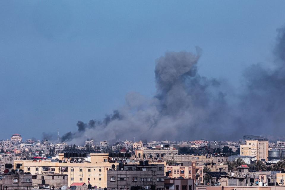 A picture taken from Rafah shows smoke billowing during Israeli bombardment over Khan Yunis in the southern Gaza Strip (AFP via Getty Images)