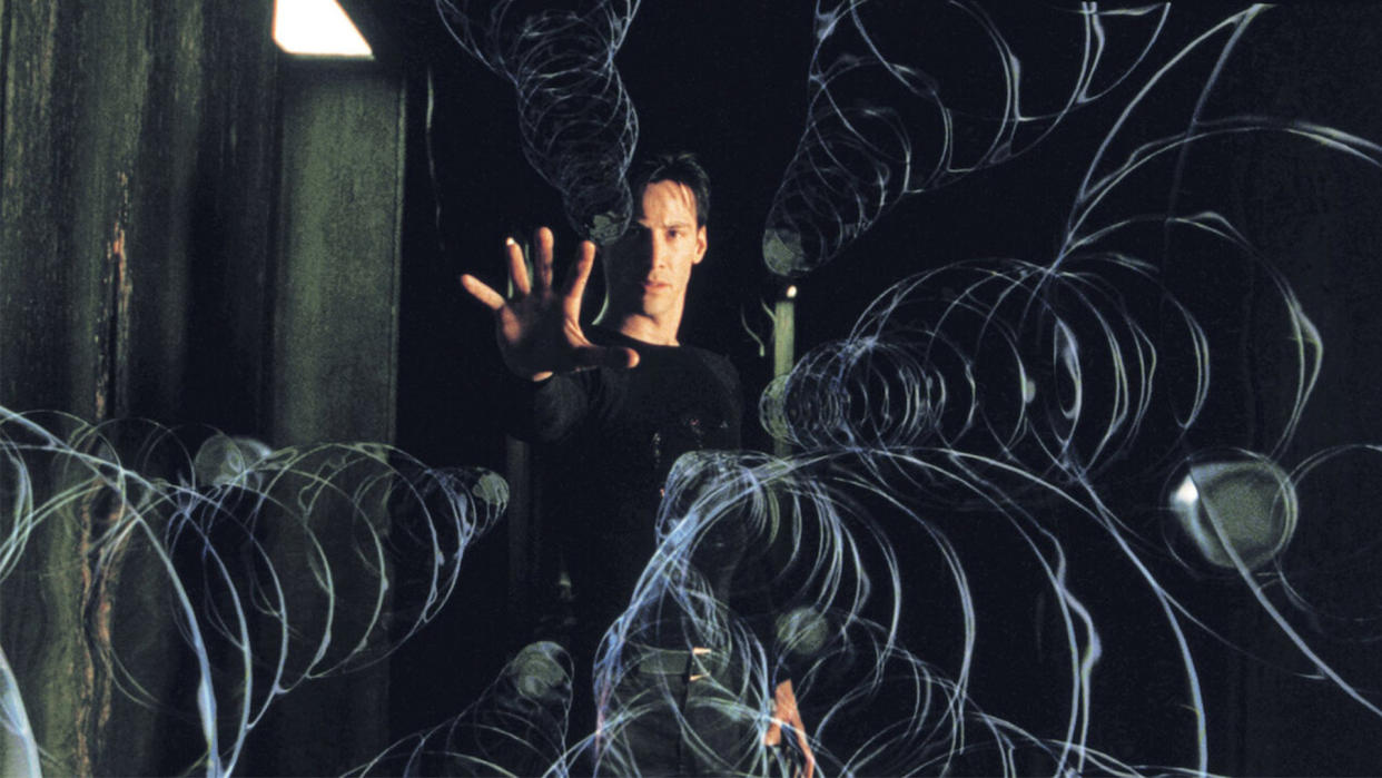  Keanu Reeves holds his hand up to stop bullets in the Matrix. 